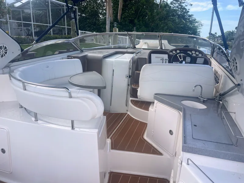 Slide: The Image of Interior of a 2005 Regal 3560 Express yacht with white seating area. - 3
