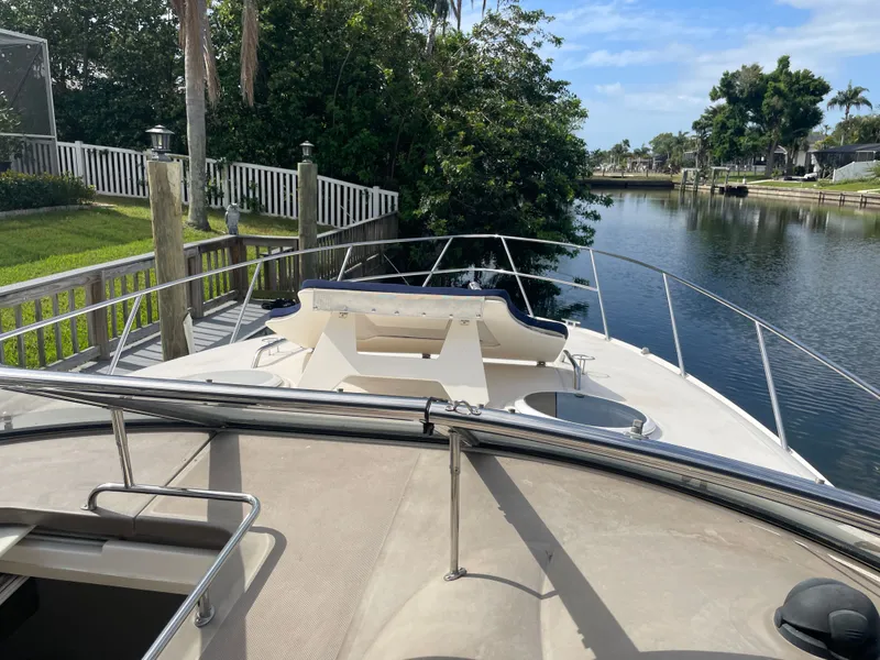 Slide: The Image of Regal 3560 Express 2005 docked on a serene river. - 30