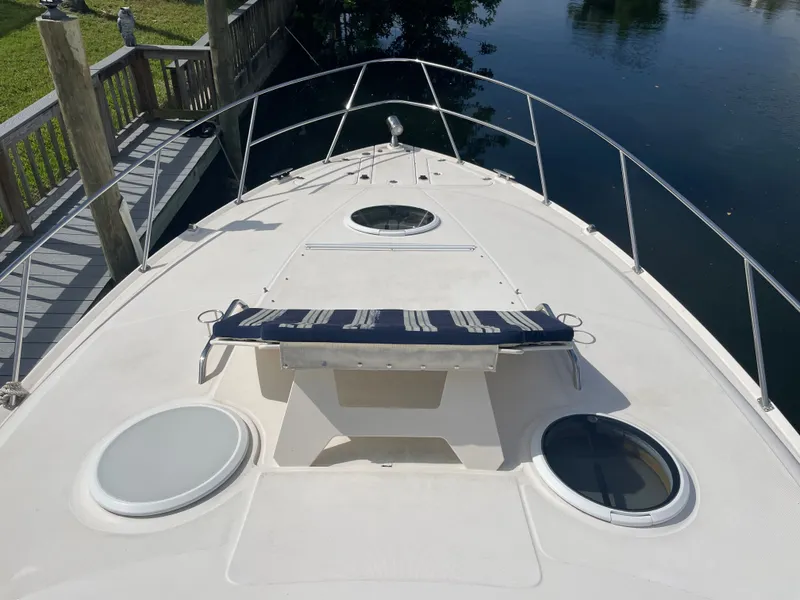 Slide: The Image of Regal 3560 Express 2005 boat deck with sunbed and portholes. - 31