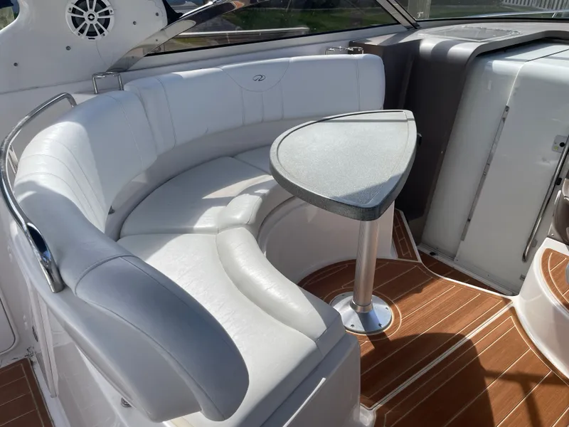 Slide: The Image of Interior of 2005 Regal 3560 Express with white seating area. - 33