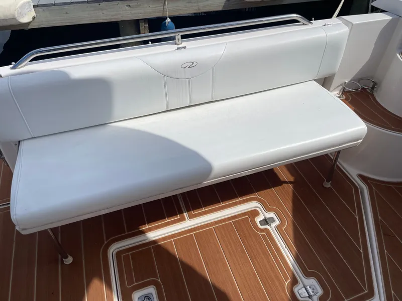 Slide: The Image of White bench seat on 2005 Regal 3560 Express boat. - 35
