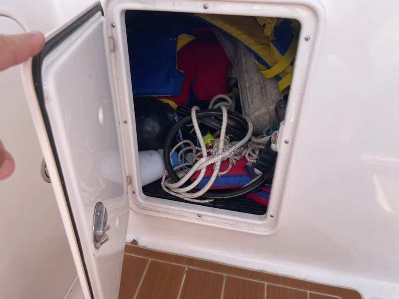 Slide: The Image of Storage compartment in Regal 3560 Express boat, filled with ropes and gear. - 36