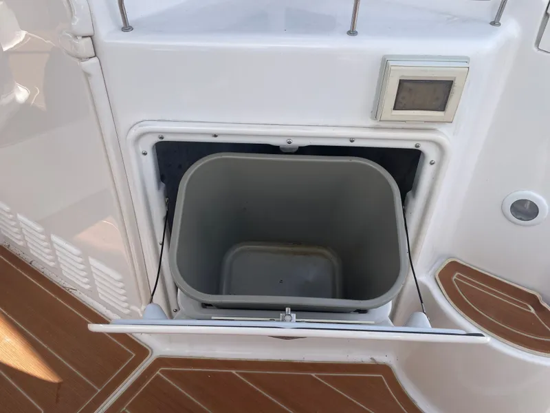 Slide: The Image of Regal 3560 Express 2005 boat trash compartment open. - 39