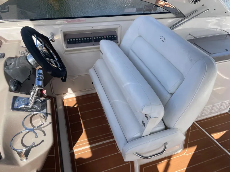 Slide: The Image of Regal 3560 Express 2005 helm with white seat and wood-look flooring. - 4