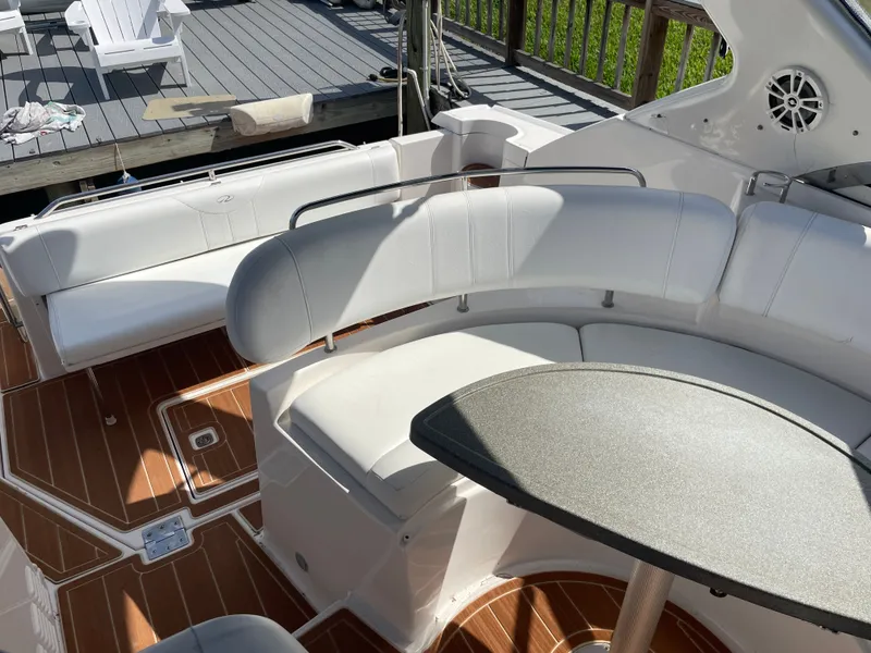 Slide: The Image of Interior of a 2005 Regal 3560 Express boat with white seating. - 41