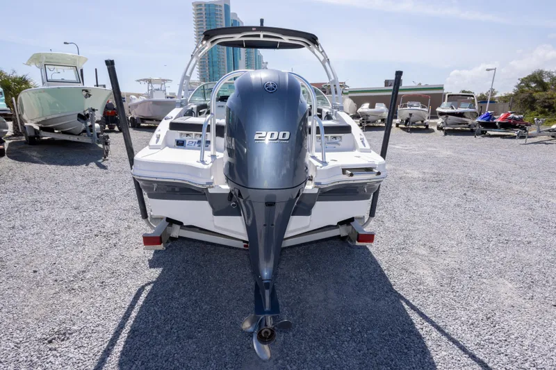 Slide: The Image of 2017 Chaparral 21 H2O Sport boat with Yamaha 200 engine, parked on gravel lot. - 10