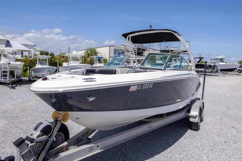 Slide: The Image of 2017 Chaparral 21 H2O Sport boat on trailer in sunny marina setting. - 12