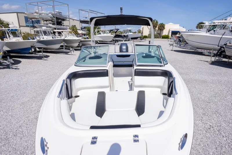 Slide: The Image of 2017 Chaparral 21 H2O Sport boat displayed in a marina with other boats. - 13