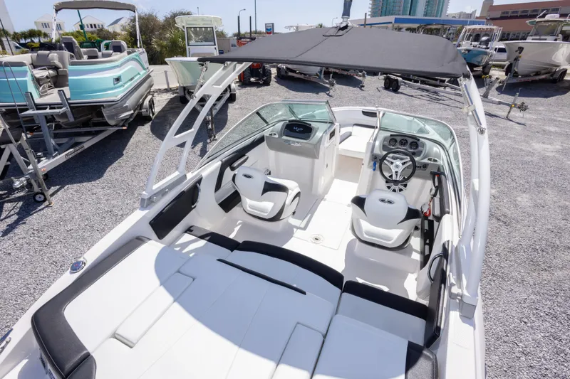 Slide: The Image of 2017 Chaparral 21 H2O Sport boat interior with seating and steering wheel. - 14