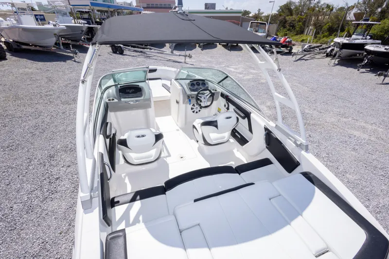Slide: The Image of 2017 Chaparral 21 H2O Sport boat interior with seating and steering wheel. - 15