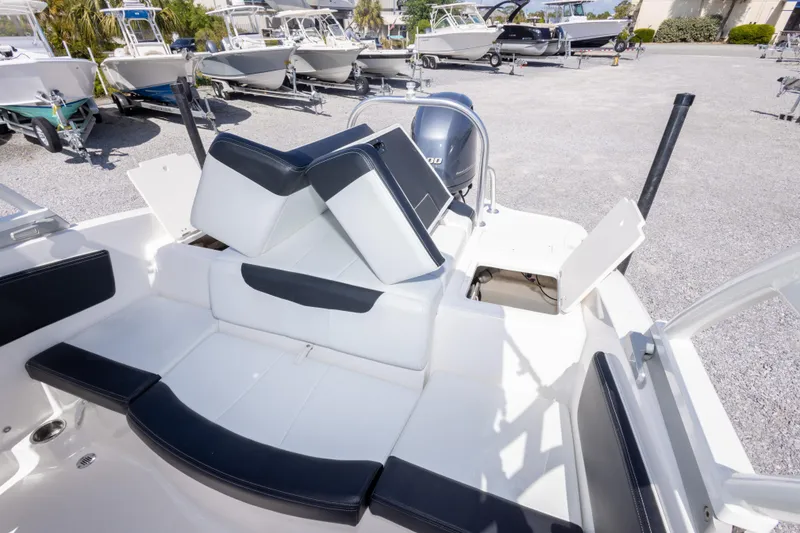Slide: The Image of 2017 Chaparral 21 H2O Sport boat interior with seating and engine view. - 21