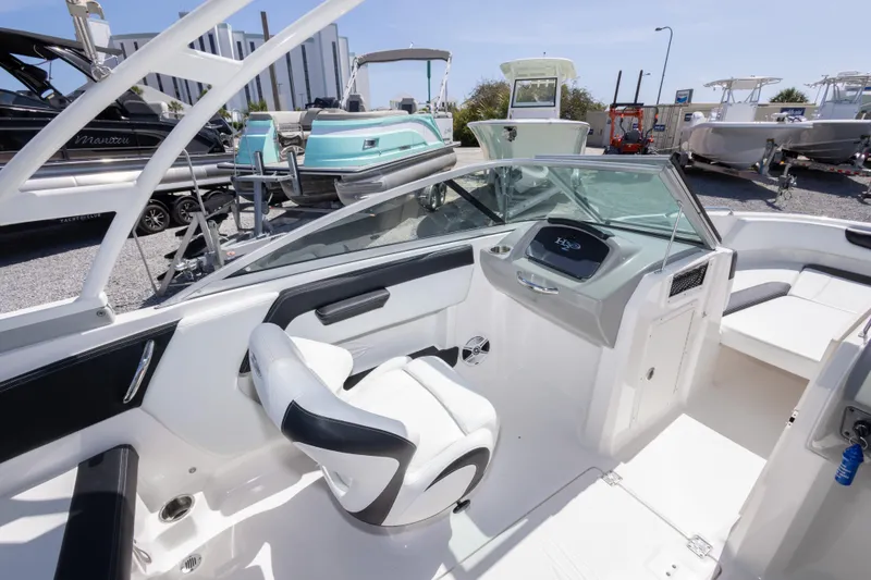 Slide: The Image of 2017 Chaparral 21 H2O Sport boat interior with sleek seating and modern dashboard. - 23