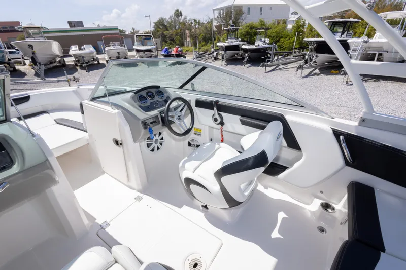 Slide: The Image of 2017 Chaparral 21 H2O Sport boat interior with steering wheel and seating. - 24