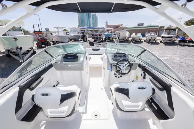 Slide: The Image of 2017 Chaparral 21 H2O Sport boat interior with steering wheel and seating. - 25