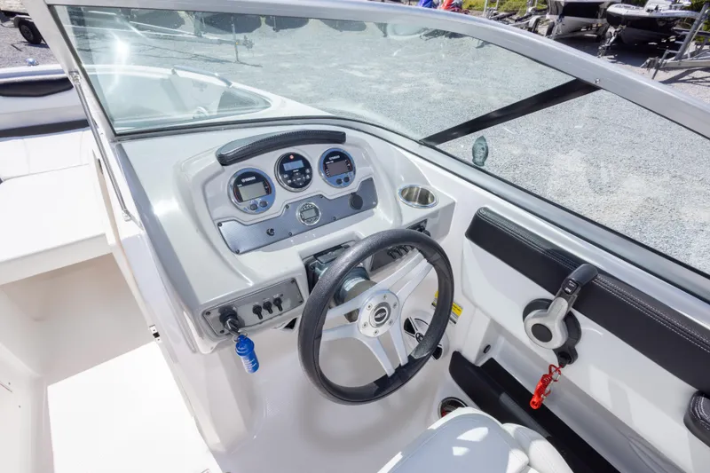 Slide: The Image of 2017 Chaparral 21 H2O Sport boat dashboard with steering wheel and gauges. - 26