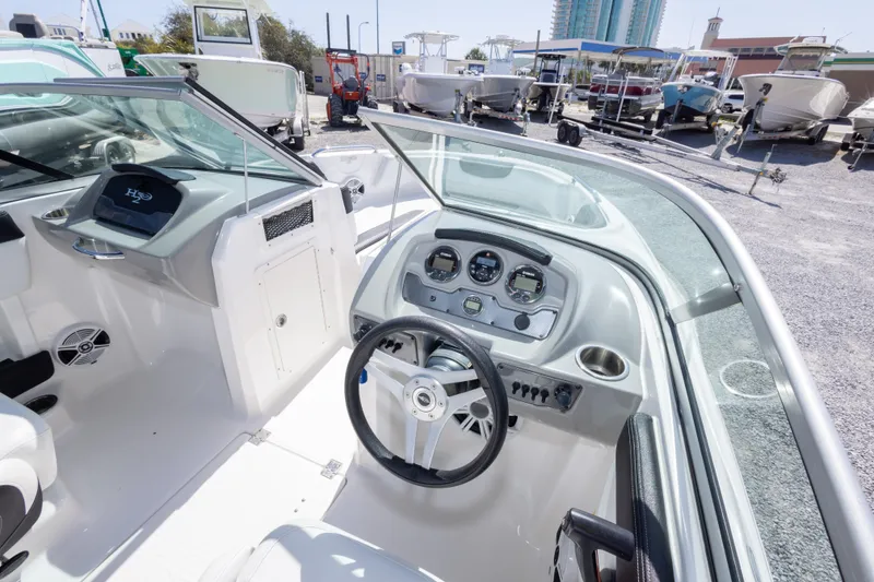 Slide: The Image of 2017 Chaparral 21 H2O Sport boat interior with steering wheel and dashboard controls. - 27