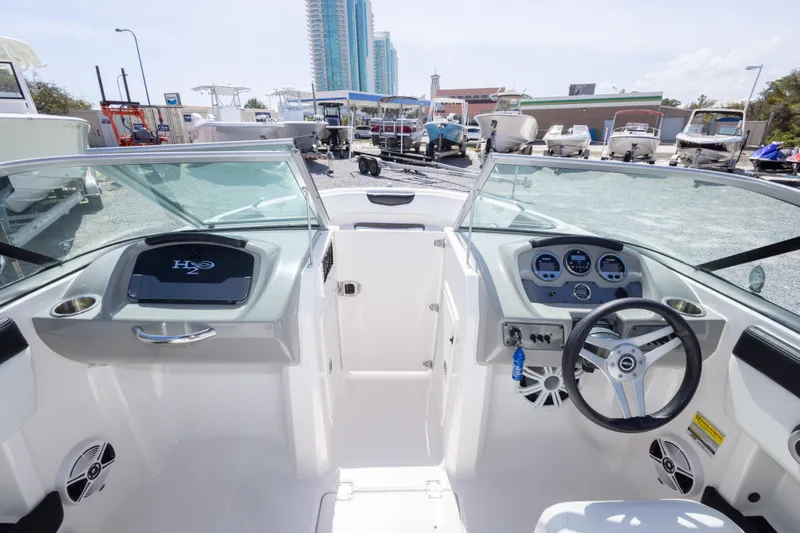 Slide: The Image of 2017 Chaparral 21 H2O Sport boat interior with steering wheel and dashboard controls. - 28