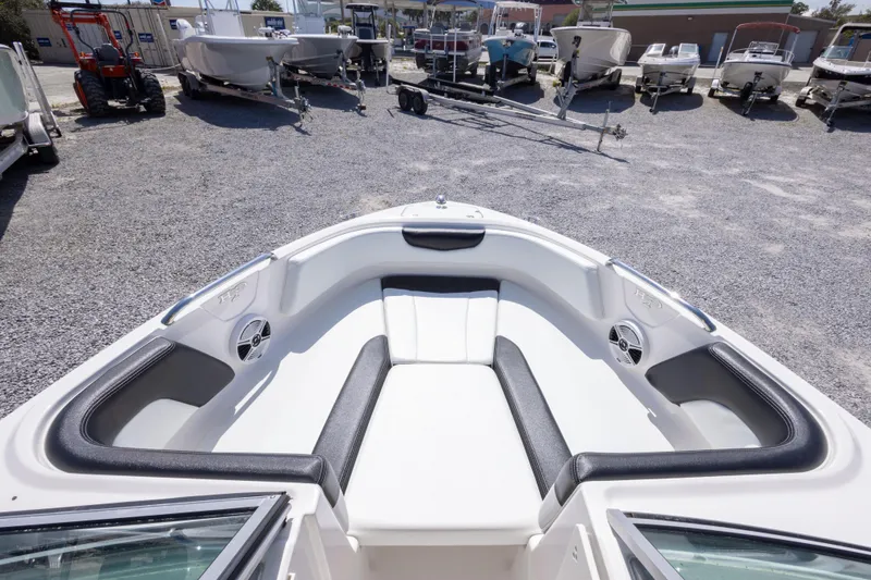 Slide: The Image of 2017 Chaparral 21 H2O Sport boat interior with seating, parked among other boats. - 29