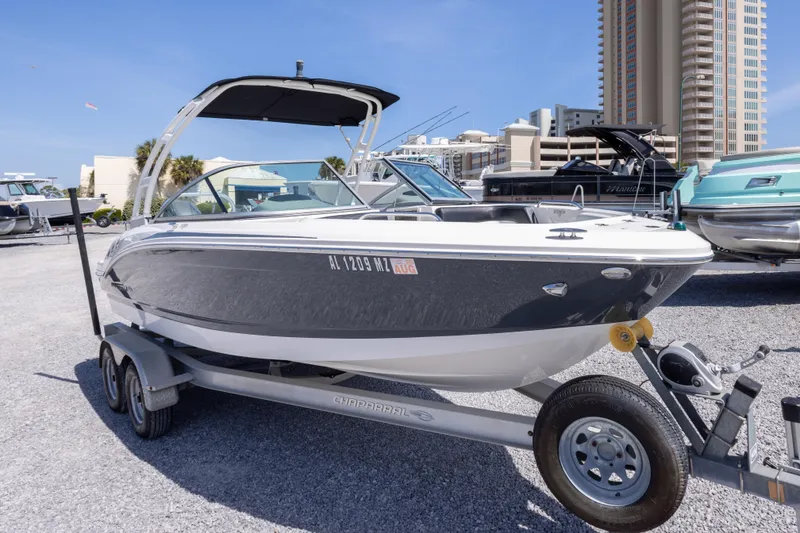 Slide: The Image of 2017 Chaparral 21 H2O Sport boat on trailer, parked outdoors near buildings. - 3