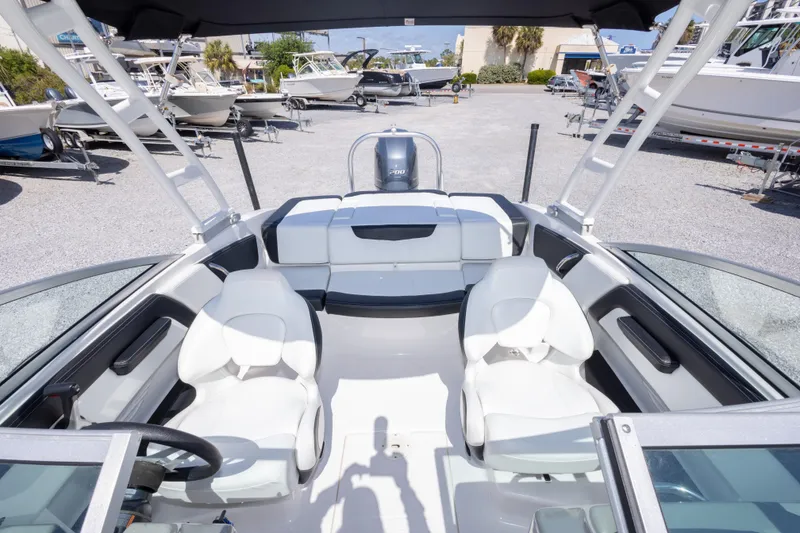 Slide: The Image of 2017 Chaparral 21 H2O Sport boat interior with white seating and steering wheel. - 32