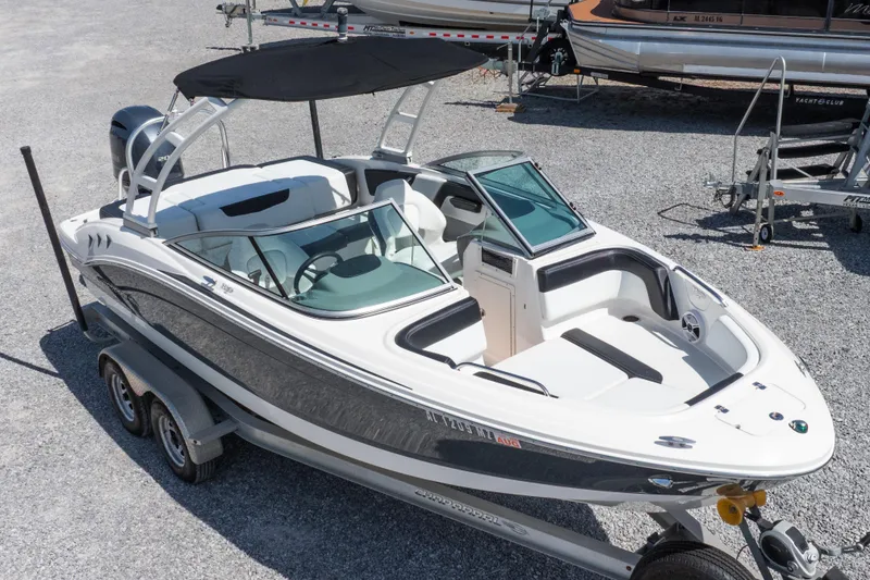 Slide: The Image of 2017 Chaparral 21 H2O Sport boat on trailer, featuring sleek design and spacious seating. - 34