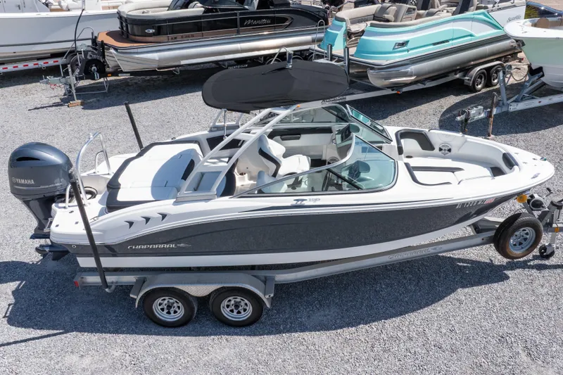 Slide: The Image of 2017 Chaparral 21 H2O Sport boat on trailer, parked in a marina. - 35