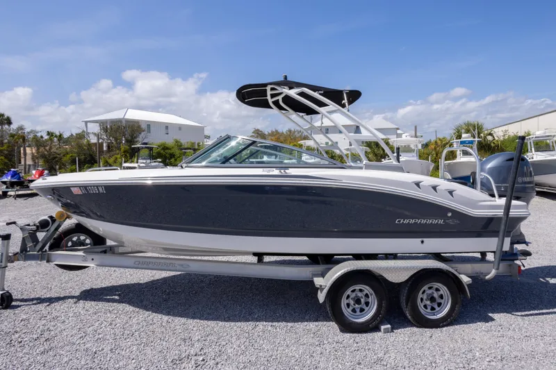 Slide: The Image of 2017 Chaparral 21 H2O Sport boat on trailer, parked outdoors under blue sky. - 4