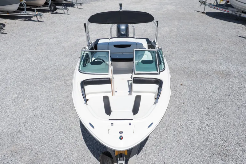 Slide: The Image of 2017 Chaparral 21 H2O Sport boat with open bow and black canopy. - 40