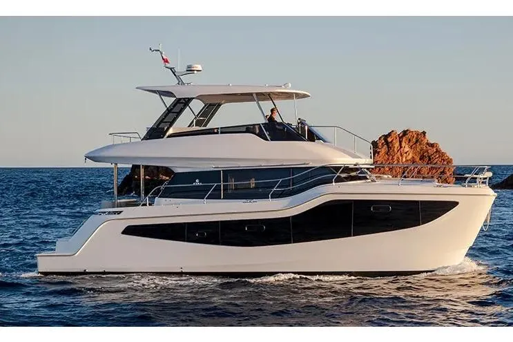 The Image of Manufacturer Provided Image: 2025 Aquila 46 Yacht cruising on open water at sunset. - 0