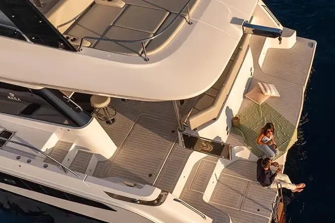 Slide: The Image of Manufacturer Provided Image: 2025 Aquila 46 Yacht deck with people relaxing, showcasing luxury and comfort. - 2