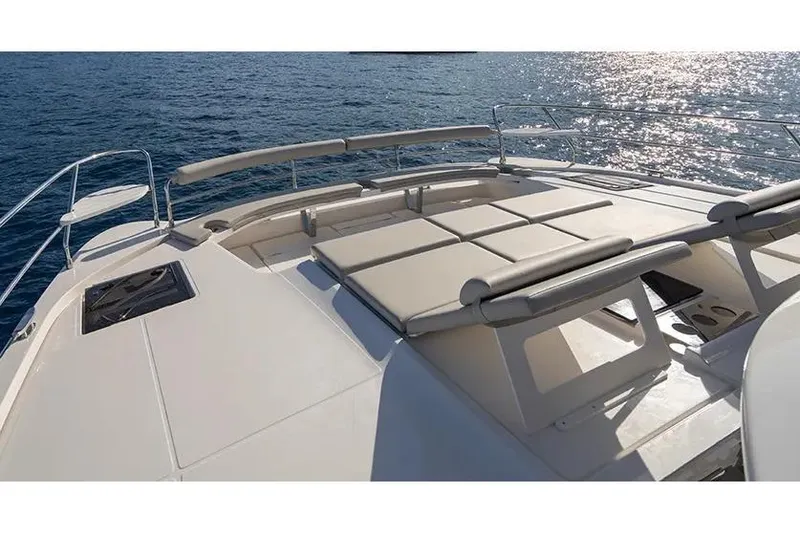 Slide: The Image of Manufacturer Provided Image: 2025 Aquila 46 Yacht deck with sun loungers on calm ocean waters. - 3