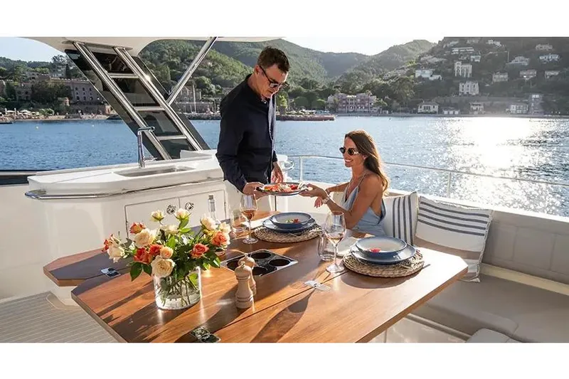 Slide: The Image of Manufacturer Provided Image: Couple dining on Aquila 46 Yacht, 2025 model, with scenic waterfront view. - 4