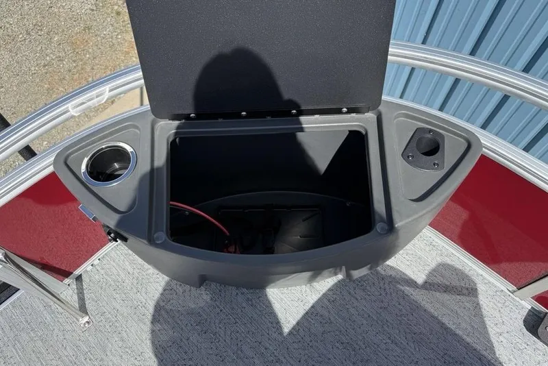 Slide: The Image of 2026 Sun Tracker Bass Buggy 18 DLX storage compartment with cup holder and open lid. - 13