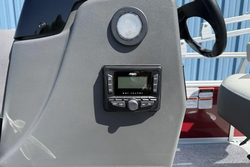 Slide: The Image of 2026 Sun Tracker Bass Buggy 18 DLX dashboard with Wet Sounds audio system. - 15