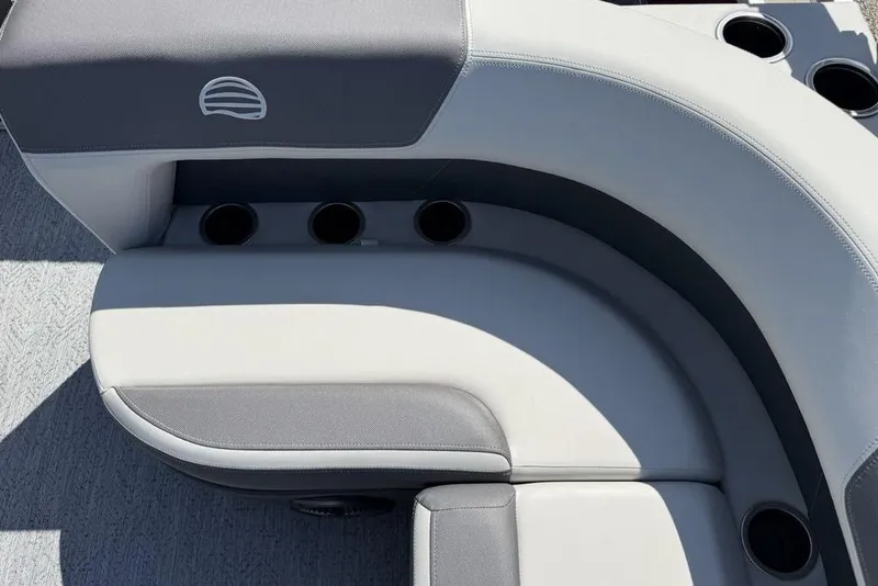 Slide: The Image of 2026 Sun Tracker Bass Buggy 18 DLX boat seating with cup holders, featuring gray upholstery. - 16