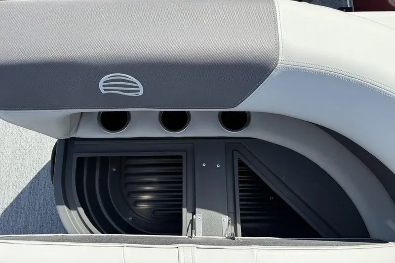 Slide: The Image of 2026 Sun Tracker Bass Buggy 18 DLX seating area with cup holders and storage compartment. - 22