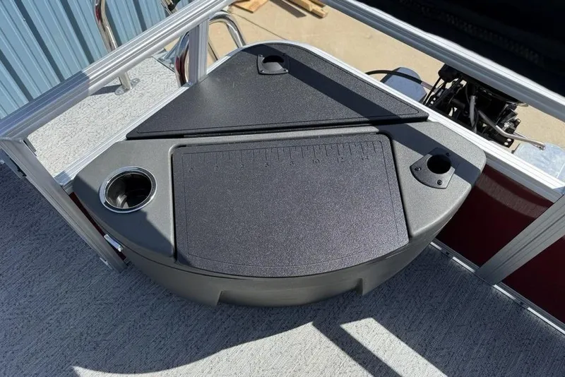 Slide: The Image of 2026 Sun Tracker Bass Buggy 18 DLX boat deck with storage compartment and cup holder. - 27