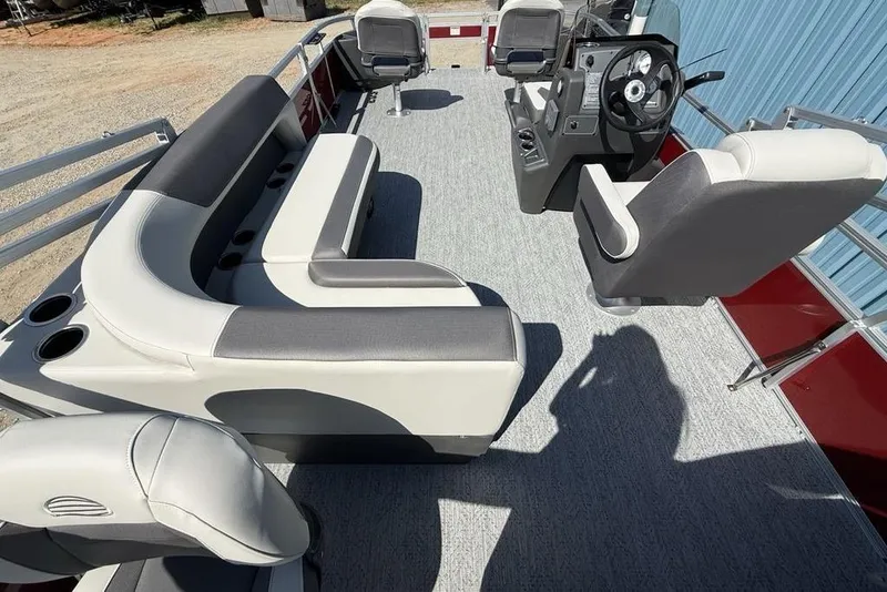 Slide: The Image of 2026 Sun Tracker Bass Buggy 18 DLX pontoon boat interior with seating and steering console. - 28