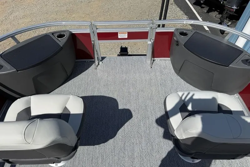 Slide: The Image of 2026 Sun Tracker Bass Buggy 18 DLX pontoon boat interior with seating and storage compartments. - 6