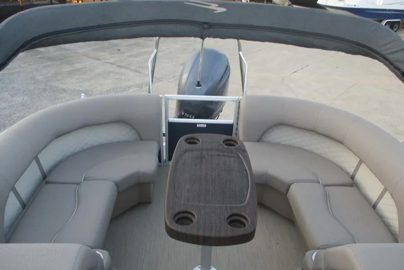 Slide: The Image of 2018 Bennington 22SSRXP pontoon boat interior with seating and table. - 6