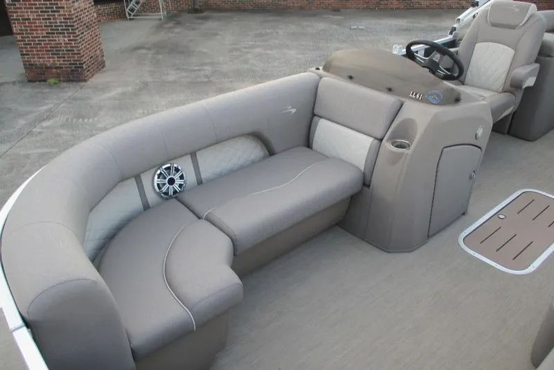 Slide: The Image of 2018 Bennington 22SSRXP boat interior with beige seating and steering console. - 7