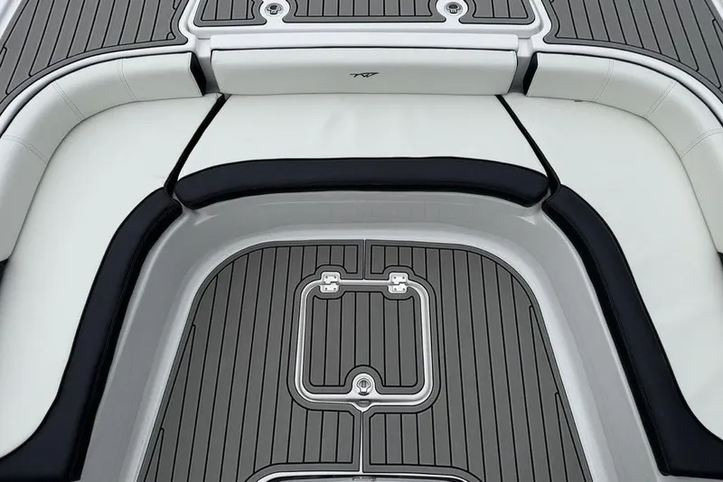 Slide: The Image of 2026 Tidewater 2500 Carolina Bay boat interior with cushioned seating and sleek flooring design. - 10