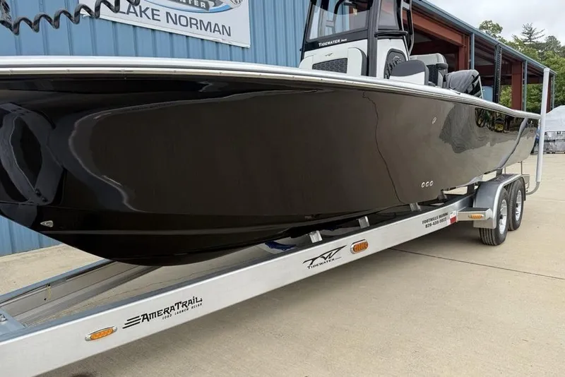 Slide: The Image of 2026 Tidewater 2500 Carolina Bay boat on trailer, displayed outdoors. - 12