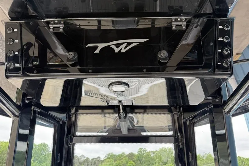 Slide: The Image of Overhead console of 2026 Tidewater 2500 Carolina Bay boat with control switches. - 23