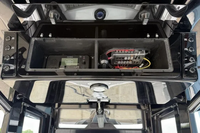 Slide: The Image of 2026 Tidewater 2500 Carolina Bay electronics compartment with Garmin device and wiring. - 26