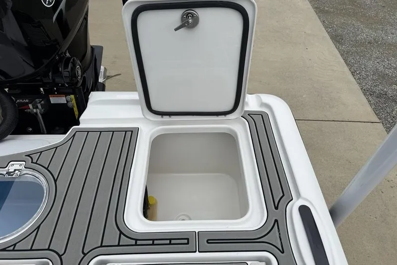 Slide: The Image of Open storage compartment on 2026 Tidewater 2500 Carolina Bay boat, featuring sleek design and secure latch. - 28
