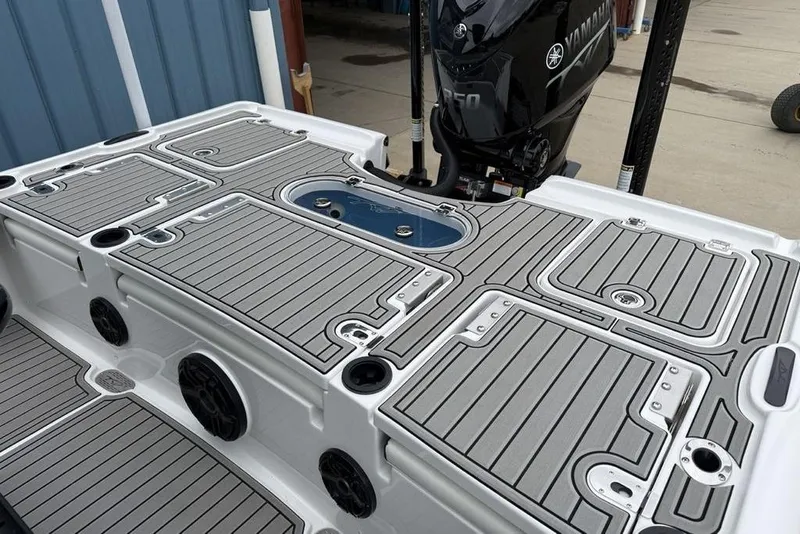 Slide: The Image of 2026 Tidewater 2500 Carolina Bay boat deck with Yamaha engine, featuring sleek design and storage compartments. - 32
