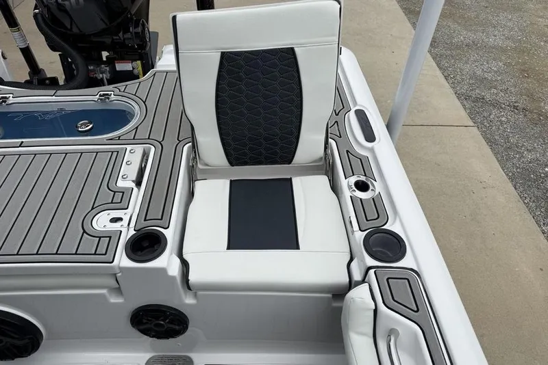 Slide: The Image of 2026 Tidewater 2500 Carolina Bay boat interior with cushioned seating and deck details. - 33