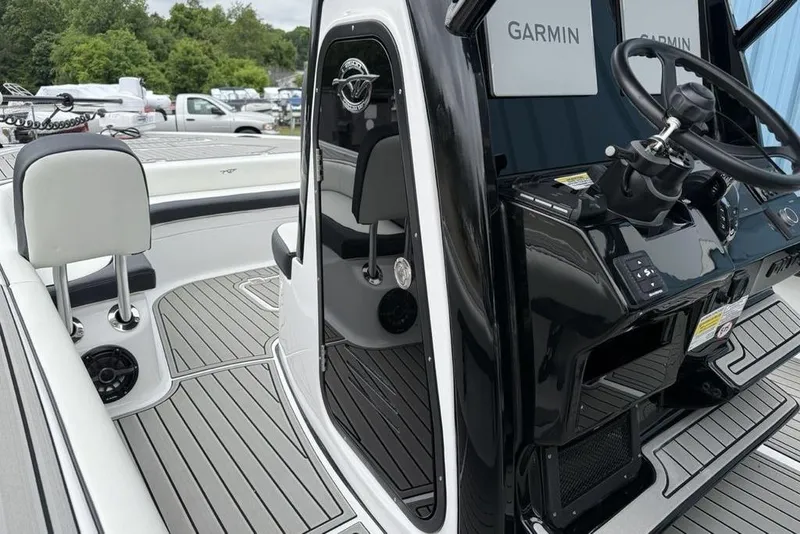 Slide: The Image of 2026 Tidewater 2500 Carolina Bay boat interior with Garmin electronics and sleek design. - 40