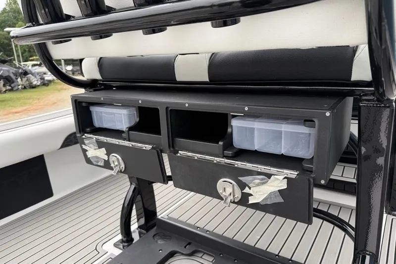 Slide: The Image of Storage compartments on a 2026 Tidewater 2500 Carolina Bay boat, featuring organized tackle boxes. - 41